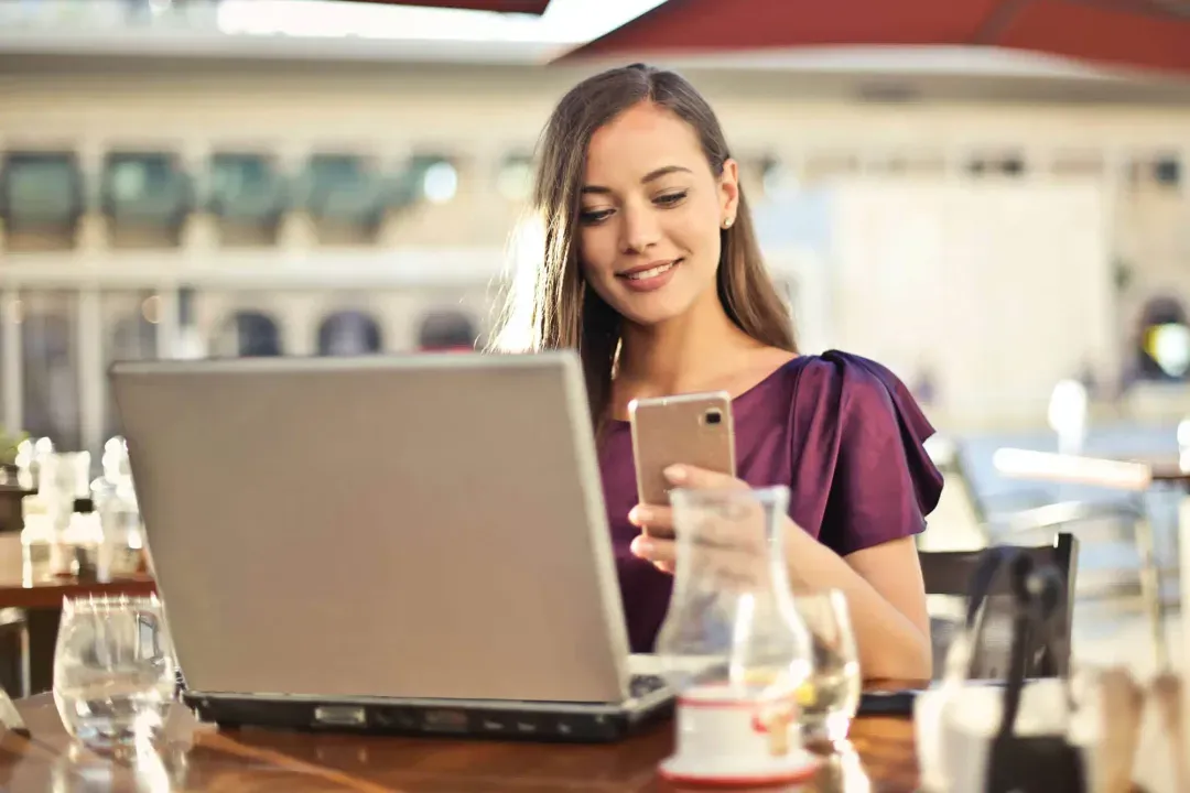 Women smiling working on a laptop