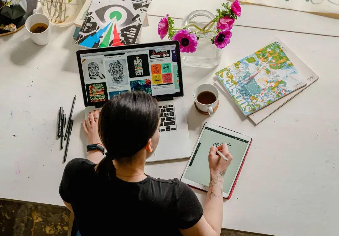 A graphic designer working on a laptop