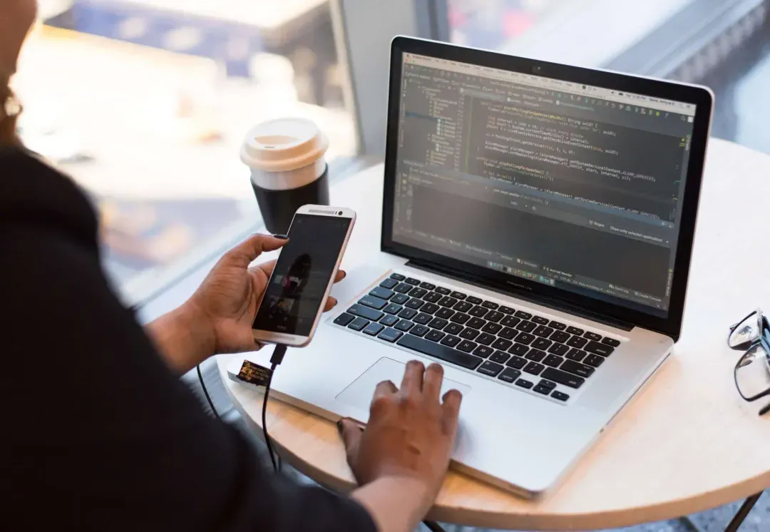 A person working on a laptop in a cafe